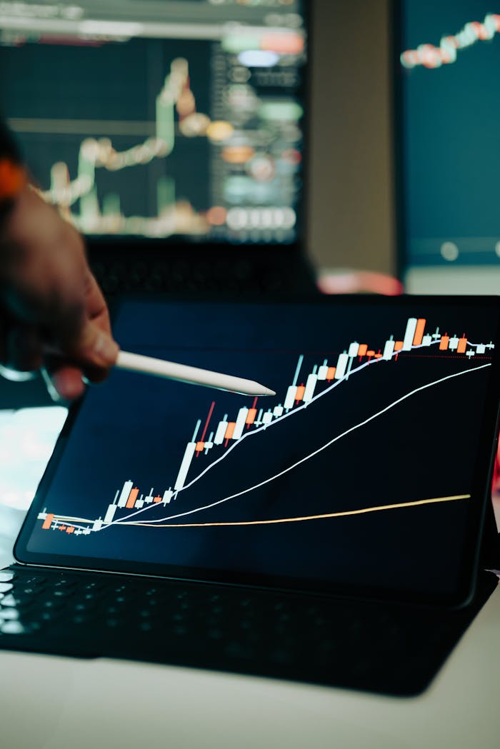 The Art of Drawing Readers In: Your attractive post title goes here Close-up of a digital tablet showing a financial growth chart with graphs and trends under analysis.