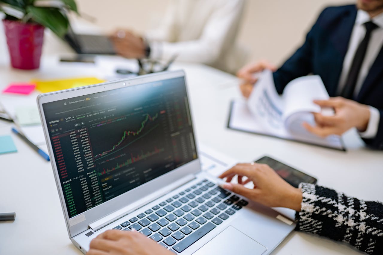 Crafting Captivating Headlines: Your awesome post title goes here Business team analyzes cryptocurrency market trends using a laptop with graphs and data.